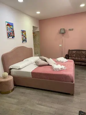 a bedroom with a bed with a red blanket at Posto al Capo in Palermo