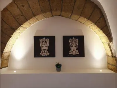 a logo with a lotus flower on a black background at Bea Home in Palermo