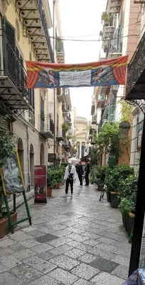 a person walking down a street with an umbrella at Bea Home in Palermo