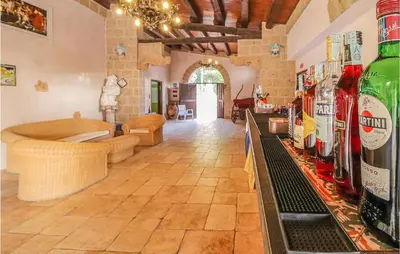 a room with a bar with bottles of wine at Pietro 2 in San Vito lo Capo