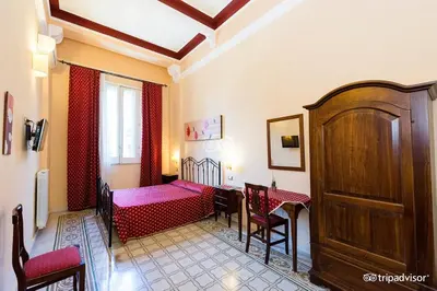 a room with a bed and a table and chairs at A Casa di Anna - Apartment in Palermo