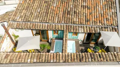 an overhead view of a building with a roof with two umbrellas at Sui Tetti di Balarm Boutique Rooms in Palermo