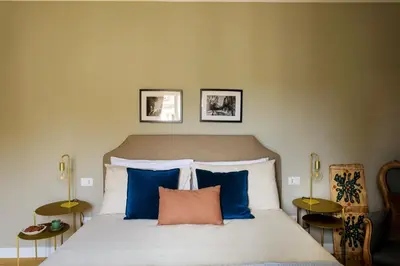 a bedroom with a bed with blue and white pillows at Sui Tetti di Balarm Boutique Rooms in Palermo