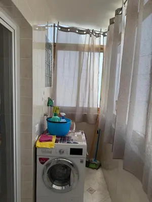 a washing machine with a bowl on top of it at Oreto Apartment in Palermo