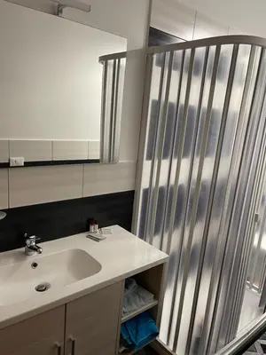 a bathroom with a sink and a shower at Oreto Apartment in Palermo