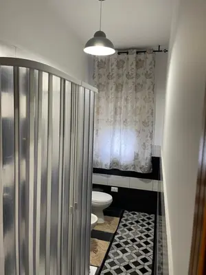 a bathroom with a toilet and a shower at Oreto Apartment in Palermo