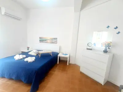 a bedroom with a blue bed with towels on it at Perla Home Speciale Vacanze 2026, Casa perfetta per gruppi coppie e famiglie vivi la Sicilia a modo tuo in Alcamo