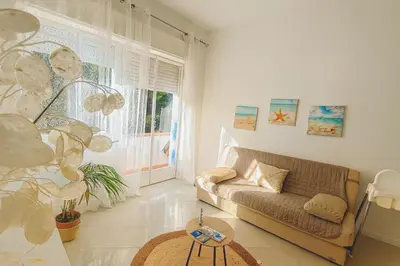 a living room with a couch and a table at Perla Home Speciale Vacanze 2026, Casa perfetta per gruppi coppie e famiglie vivi la Sicilia a modo tuo in Alcamo