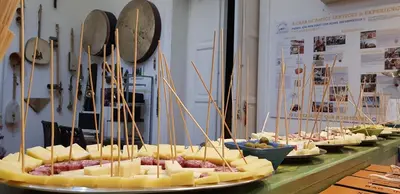a display of cheese dishes on a table with utensils at A Casa di Amici in Palermo