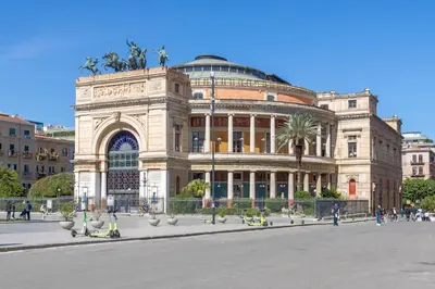 a large building with a palm tree on top of it at A Casa di Amici in Palermo