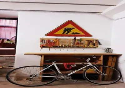 a bike parked in a room with a hazard sign at A Casa di Amici in Palermo