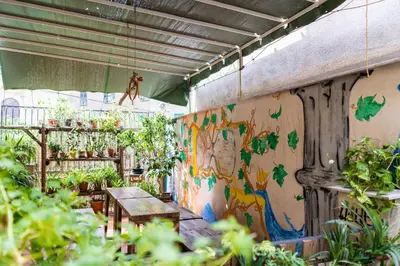 a room with a table and some plants at A Casa di Amici in Palermo