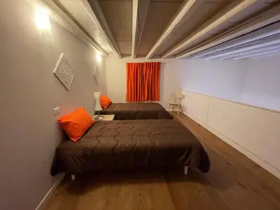 a room with two beds and a red curtain at 100 PASSI in Palermo