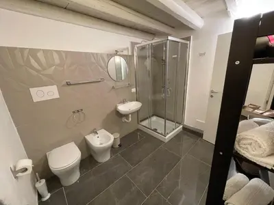 a bathroom with a toilet and a sink and a shower at 100 PASSI in Palermo