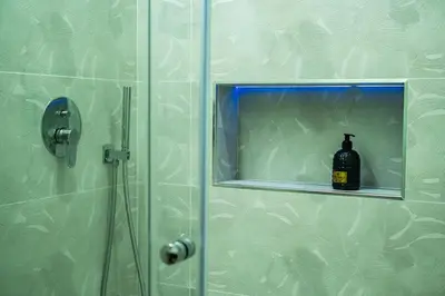 a shower with a shower head in a bathroom at Daria’s home apartament in Palermo