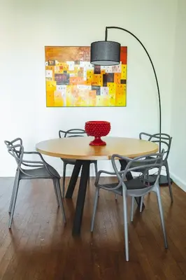 a table with chairs and a vase on top of it at ChiChi Home in Palermo