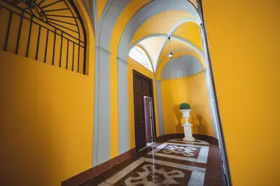 a mirror in a room with a yellow wall at ChiChi Home in Palermo