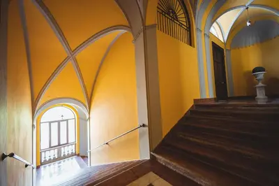 an empty hallway with yellow walls and a staircase at ChiChi Home in Palermo