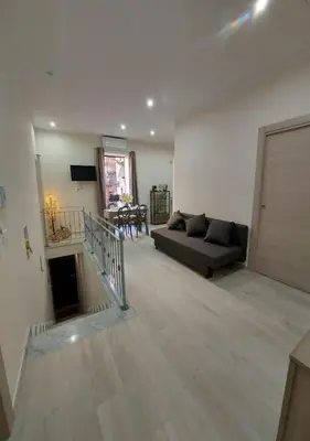 a large living room with a couch and a table at Le Due Pigne - Palermo in Palermo