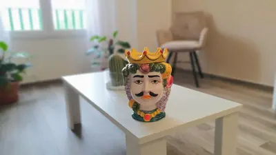a statue of a head with a crown on a table at Garibaldi Rooms 29 - Piazza Marina a Palermo - In pieno Centro. in Palermo