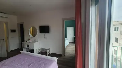 a bedroom with a bed and a desk and a mirror at Garibaldi Rooms 29 - Piazza Marina a Palermo - In pieno Centro. in Palermo