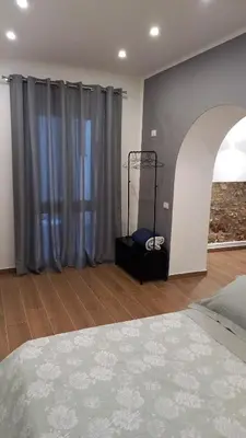 a bedroom with a bed and a window with curtains at Casa Villafilippina in Palermo