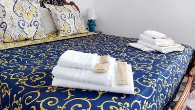 a room with a bed with towels on it at VFH Villa Flavia Eco B&B - 50 metri dal mare in Santa Flavia
