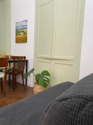 a bedroom with a bed and a dining room table at Il gallo di Eracle - Charming suites & rooms in Termini Imerese