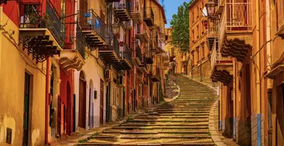 an alley with stone stairs in an alley between buildings at Il gallo di Eracle - Charming suites & rooms in Termini Imerese