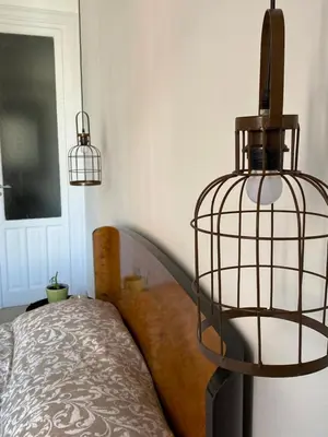 a room with a bed with a bird cage on it at Il gallo di Eracle - Charming suites & rooms in Termini Imerese