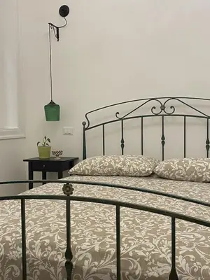 a bedroom with a bed with a metal frame at Il gallo di Eracle - Charming suites & rooms in Termini Imerese
