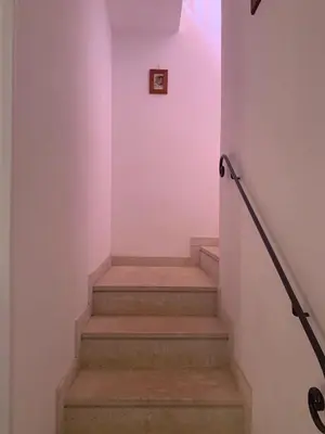 a stairway with a pink wall and some stairs at MAKARI, Villetta Rocca Pirciata in Macari