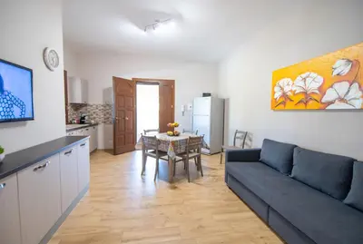 a living room with a couch and a table at Deluxe Sicily Villa in Buonfornello