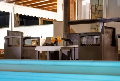 a patio with a table and chairs with drinks on it at Deluxe Sicily Villa in Buonfornello