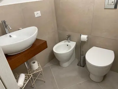 a bathroom with a white sink and a toilet at Cathedral House Design in Palermo