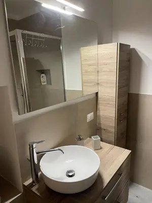 a bathroom with a white sink and a mirror at Cathedral House Design in Palermo