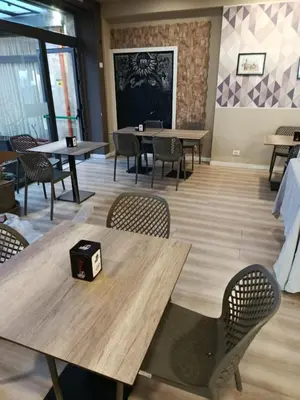 a dining room with tables and chairs and a wall at Hotel Elite Palermo Centro in Palermo