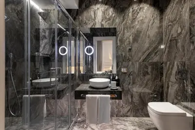 a bathroom with two sinks and a shower and a toilet at Grand Hotel Et Des Palmes in Palermo