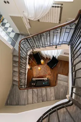 a spiral staircase with a table in a room at Hotel Ambasciatori in Palermo