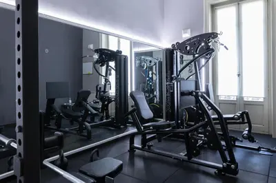 a gym with several treadmills and tread machines at Hotel Ambasciatori in Palermo