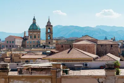 a view of a city with mountains in the background at Hotel Ambasciatori in Palermo