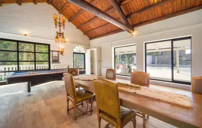 a dining room with a table and a pool table at Dimora Di Famiglia in Belmonte Mezzagno