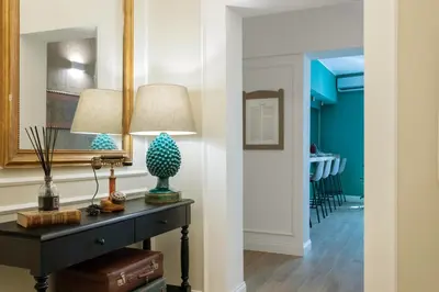 a hallway with a table with a lamp on it at Vossia Luxury Rooms & Sicilian Living in Palermo