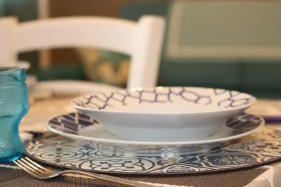 a bowl sitting on a plate on a table at Casa de Paoli - Vista Mare Arenella, Palermo con Parcheggio Privato in Palermo