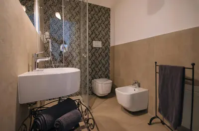 a bathroom with a sink and a toilet at Boutique B&B Vintage in Palermo