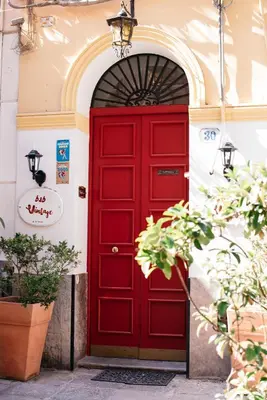 a red door in a building with an arch at Boutique B&B Vintage in Palermo