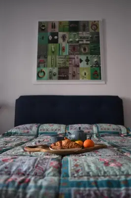 a plate of food on a bed with a plate of fruit at Boutique B&B Vintage in Palermo
