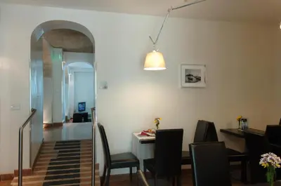 a dining room with a table and chairs and a light at Ucciardhome Hotel in Palermo