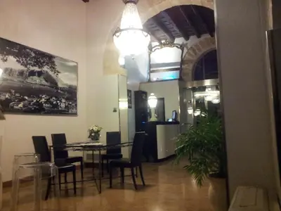 a dining room with a table and chairs at Ucciardhome Hotel in Palermo