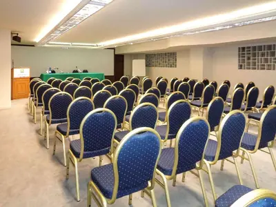 a room with rows of chairs in a classroom at President Hotel Palermo in Palermo